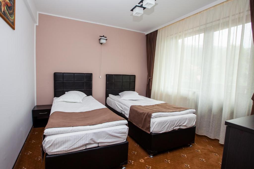 Postel nebo postele na pokoji v ubytování Pensiunea Noni