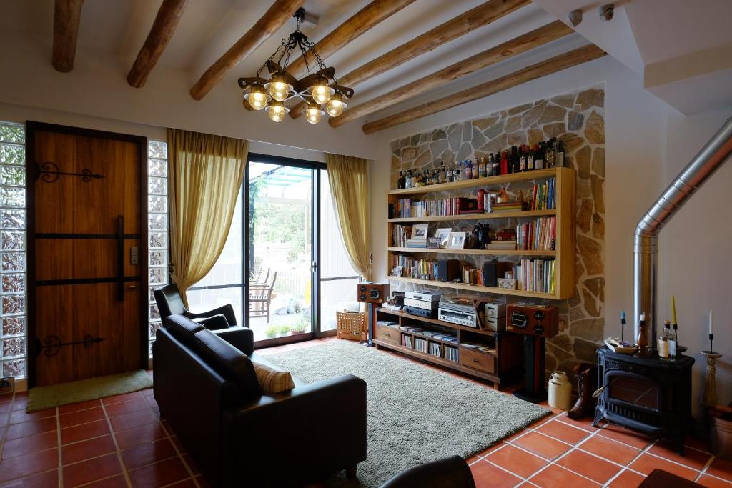 a living room with two chairs and a fireplace at Shire Homestay in Luodong