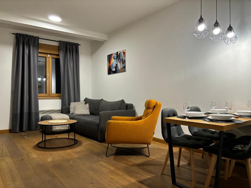 a living room with a couch and a table at Tenea Apartment & SPA in Zlatibor