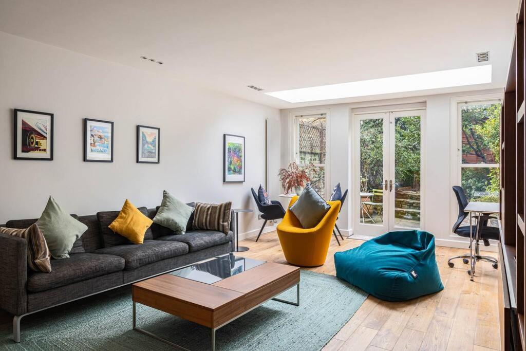 a living room with a couch and a table at A Grand Four Bedroom Townhouse at Knightsbridge in London
