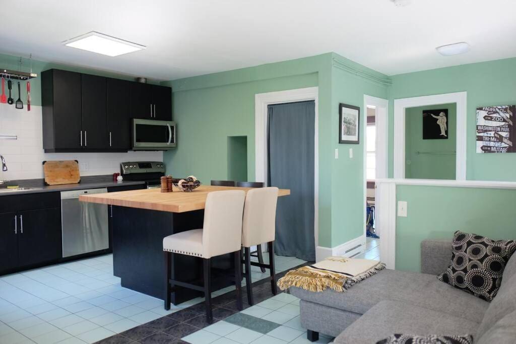 a kitchen with a table and a couch in a room at Comfy Apt, Top Floor, Excellent Kitchen in Halifax