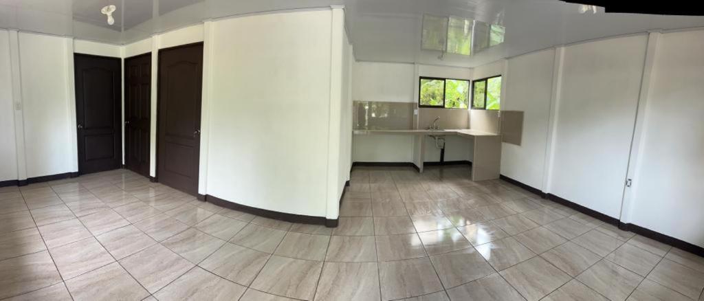 an empty room with white walls and a tile floor at casa playa negra in Puerto Limón