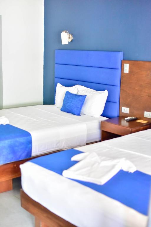 Кровать или кровати в номере Republik Hotel, Bistro and Nightclub on Site