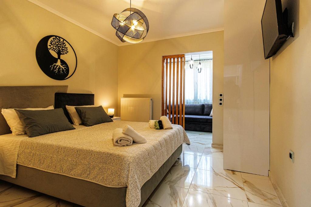 a bedroom with a large bed and a television at Armonia Holiday Home Corfu with King size Bed and Private Garden in Áyios Pandeleḯmon