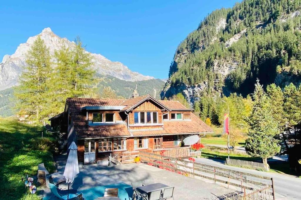 a house in the mountains with a pool at Cozy Apartment in Vintage House in Kandersteg in Kandersteg