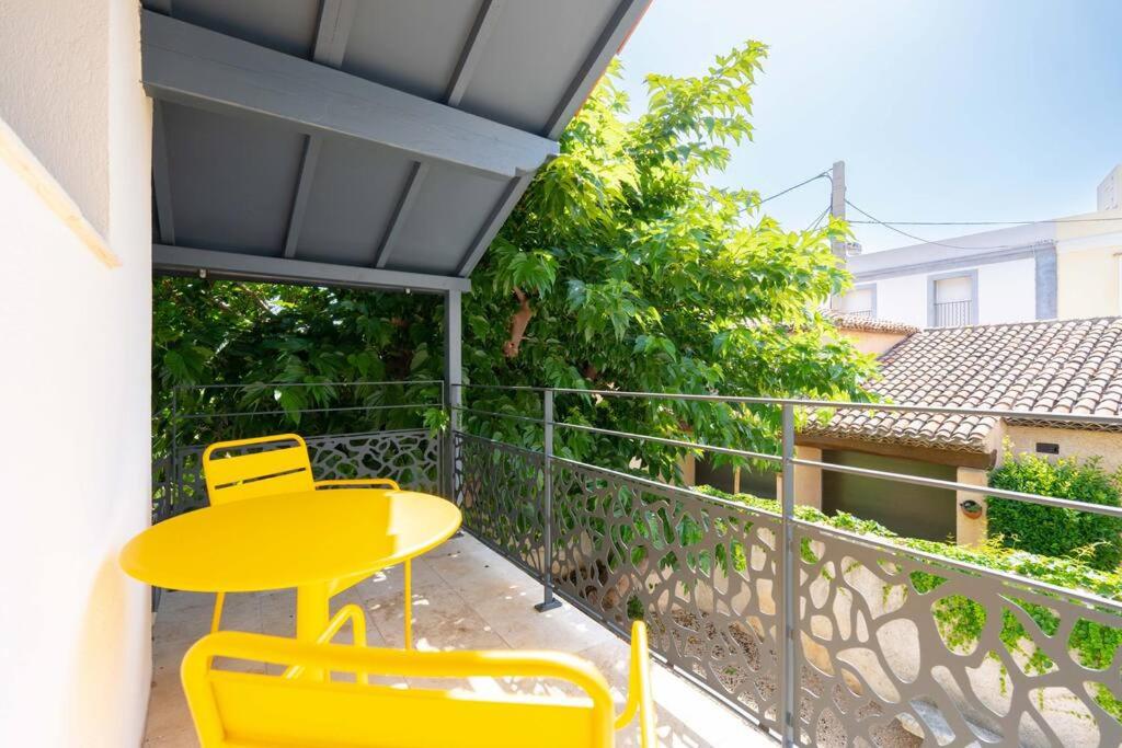 a yellow table and chairs on a balcony at Maison avec jardin &quot;les Néréïdes&quot; port et plage de la Pointe Rouge Marseille in Marseille