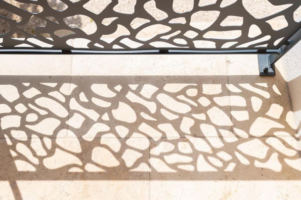 a black and white metal bed frame with a shadow at Maison avec jardin &quot;les Néréïdes&quot; port et plage de la Pointe Rouge Marseille in Marseille