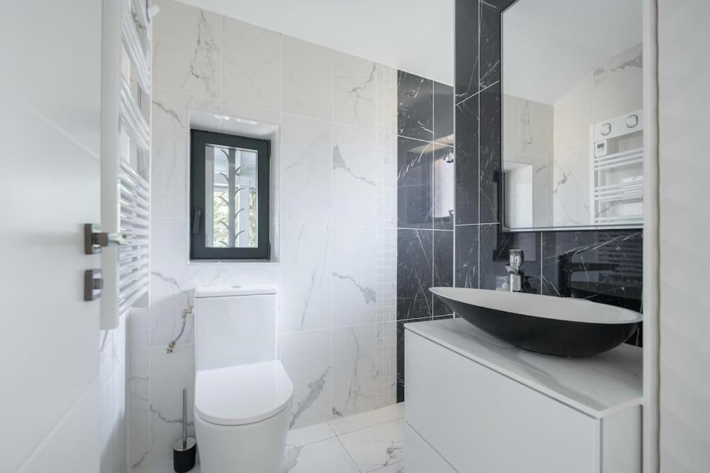 a white bathroom with a sink and a toilet at Maison avec jardin &quot;les Néréïdes&quot; port et plage de la Pointe Rouge Marseille in Marseille