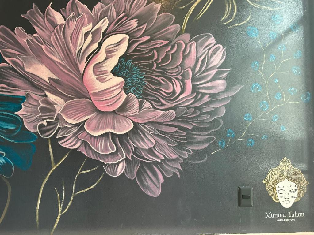 a painting of a flower on a wall at Hotel Boutique Murana Tulum in Tulum