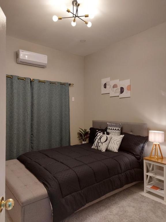 a bedroom with a large bed and a ceiling fan at Malik SuitesGY 