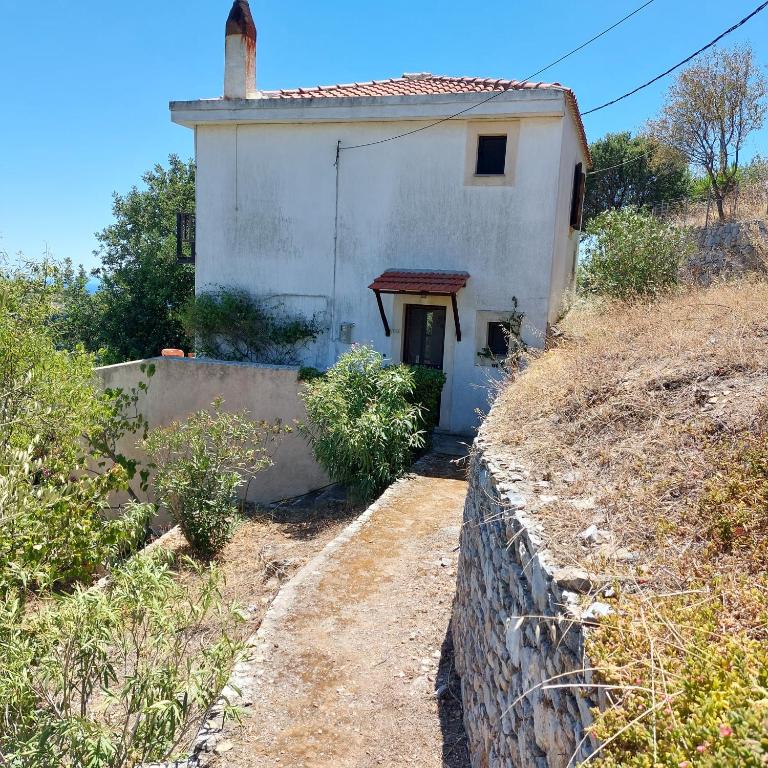 a small white house on the side of a hill at Sunrise house Alonnisos in Alonnisos