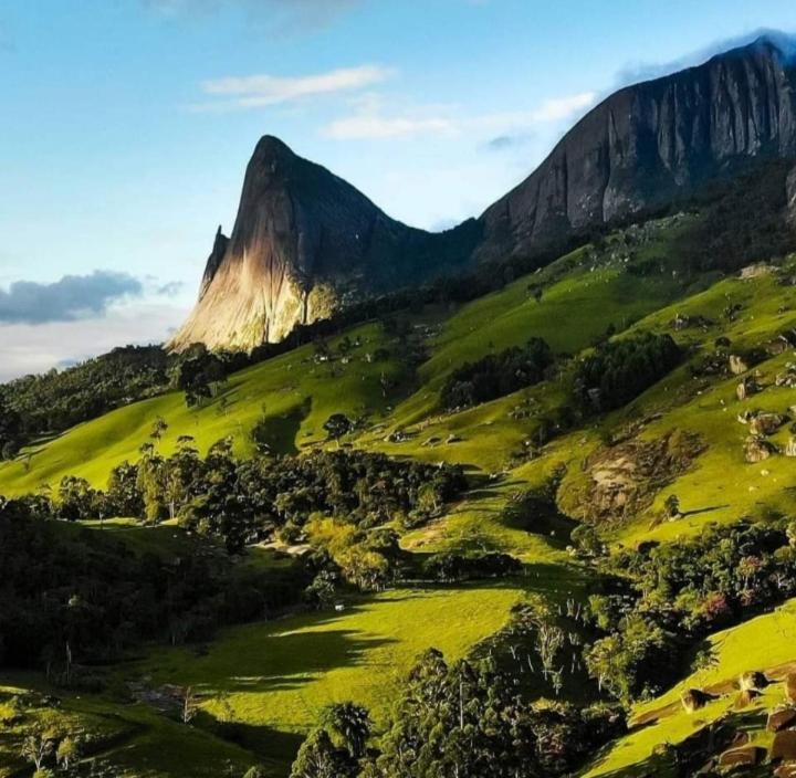 une colline verdoyante avec une montagne en arrière-plan dans l'établissement Aconchego 2, à Domingos Martins