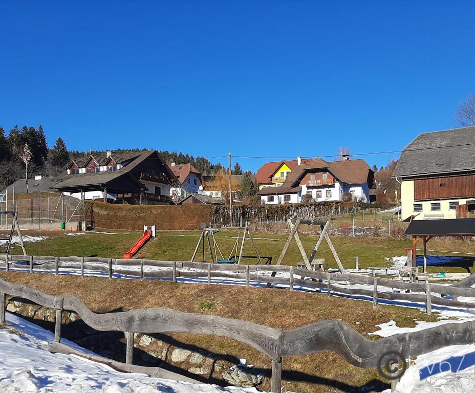 a park with a playground in the snow at Jogilation in Sankt Jakob im Walde