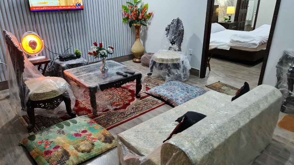 a living room with a couch and a table at Patriata Luxury Suits in Murree