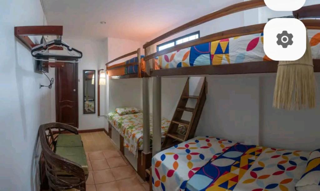 a bedroom with two bunk beds and a bed at Casa Mañana in Puerto López