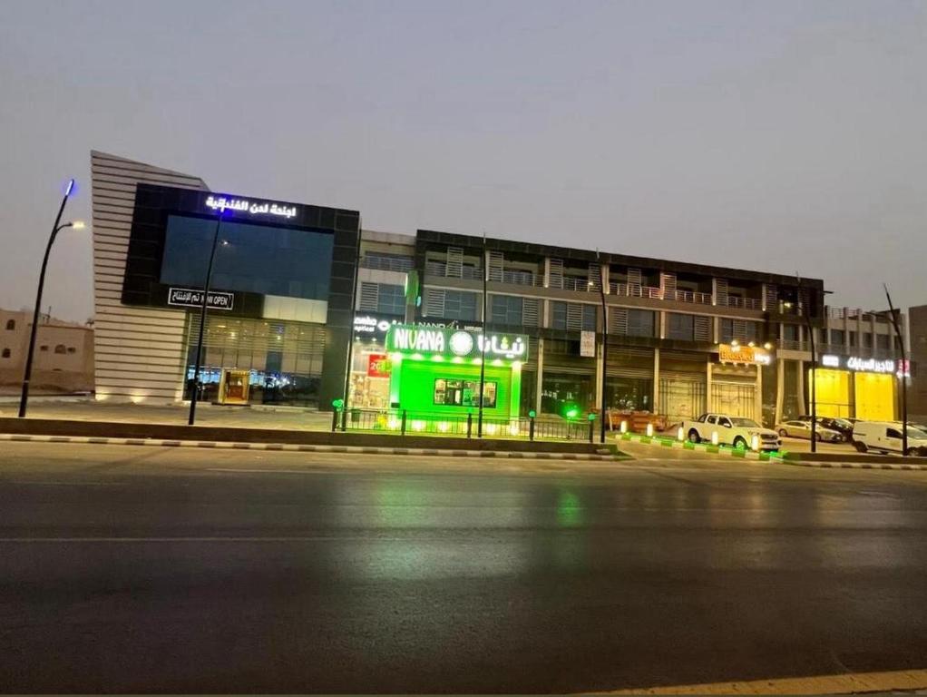 a building on the side of a street at night at Sokon Ladn Hotel in Riyadh