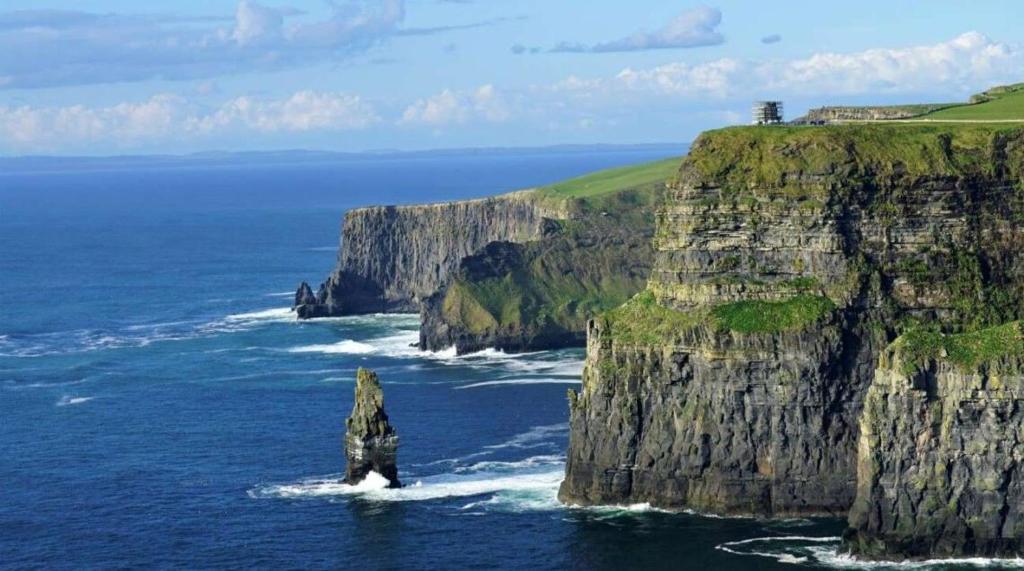 a large rock in the ocean next to the ocean at Coastal View House in Doolin