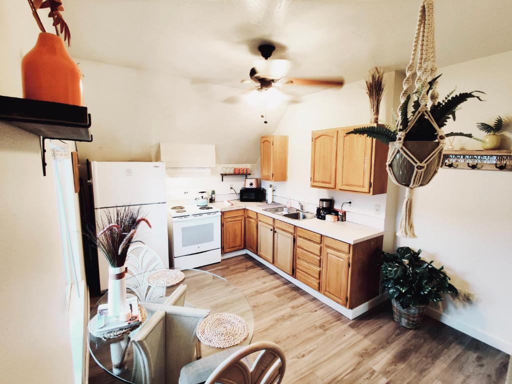a kitchen with wooden cabinets and white appliances at Soleil Salem in Salem