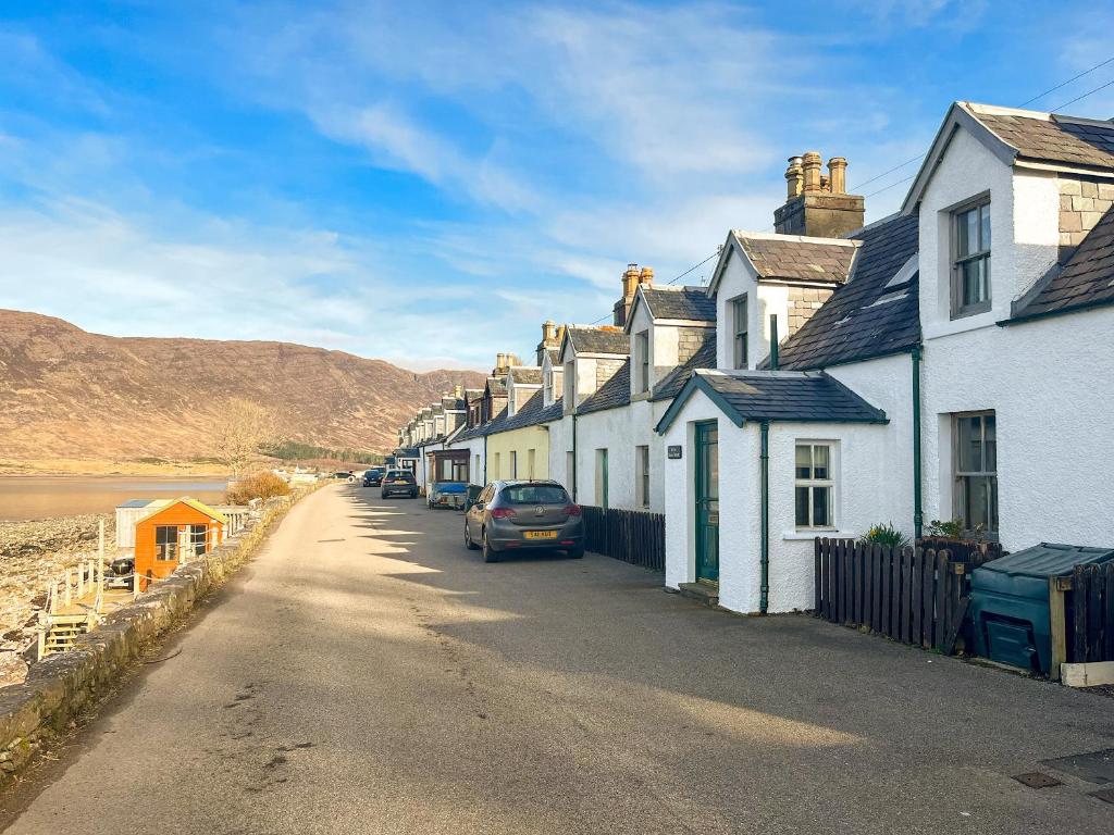 a row of houses on the side of a street at The Fishermans Cottage in Applecross