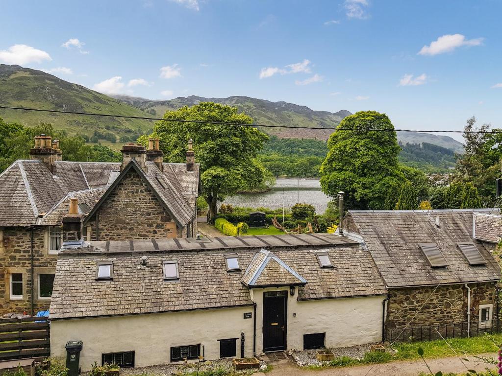 a group of houses with mountains in the background at Craigdarroch Cottage in Saint Fillans