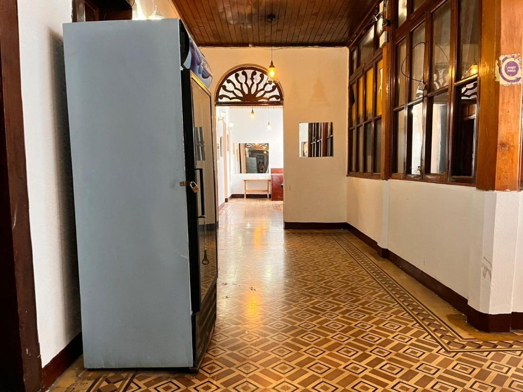 a hallway with a refrigerator in the middle of a room at Hotel Letona in Guatemala