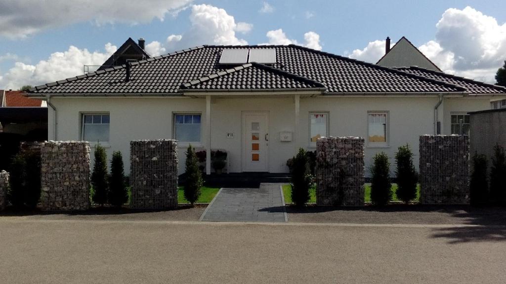 a white house with a tiled roof at Sweet Home in Löhne