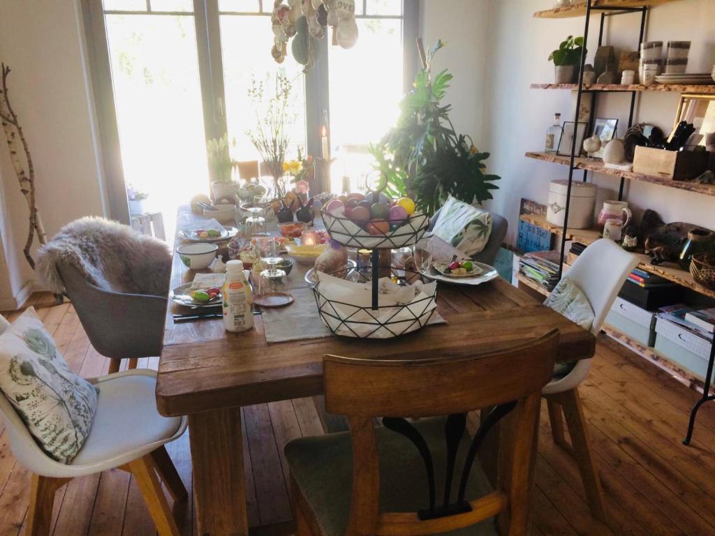 a wooden table with food on it in a living room at Ks Kotten Bed and Breakfast in Rees