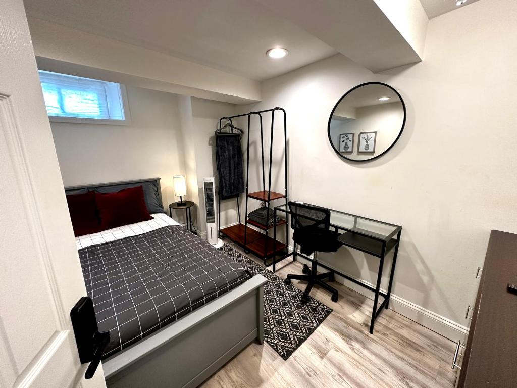 a bedroom with a bed and a desk and a mirror at 4-A Diamond in Yonkers in Yonkers
