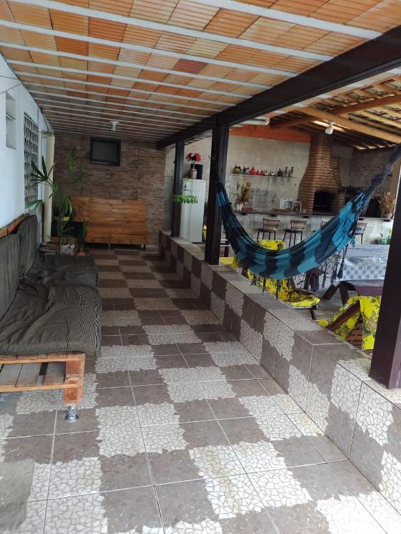 a patio with hammocks on the side of a building at Sitio Cantinho da Alegria in Confins