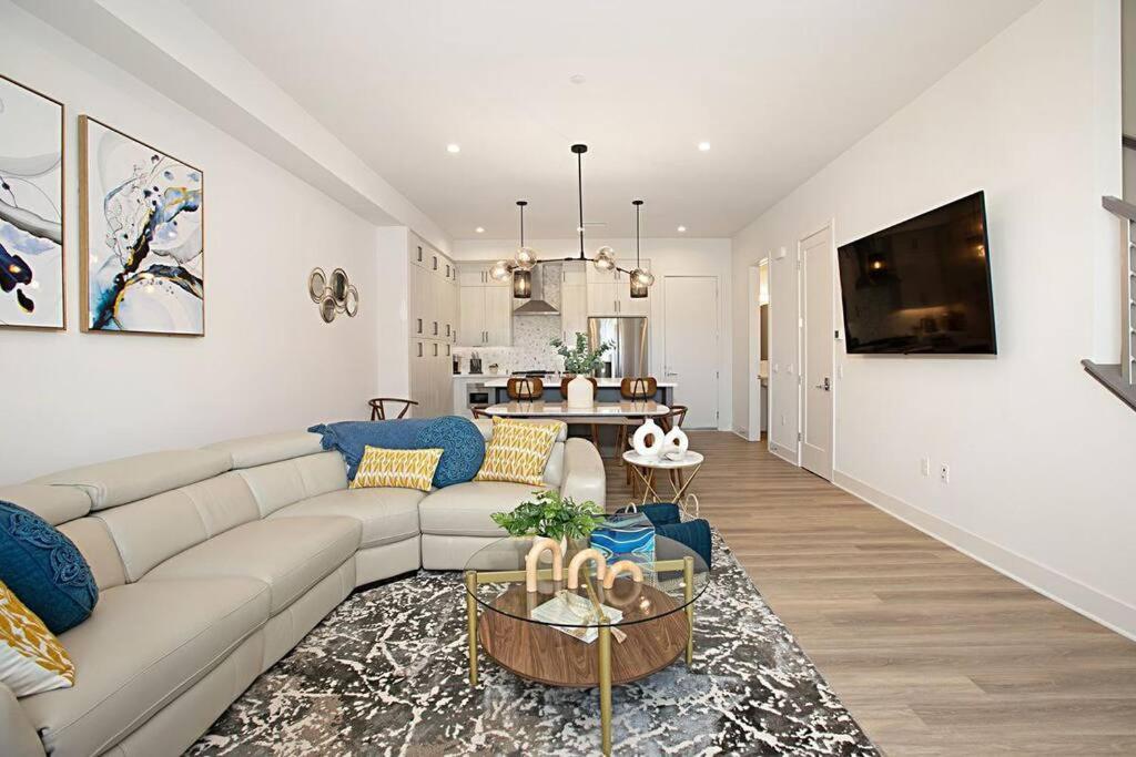 ein Wohnzimmer mit einem Sofa und einem Tisch in der Unterkunft Luxury NEW Residence with Private Rooftop, Downtown in minutes in San Diego