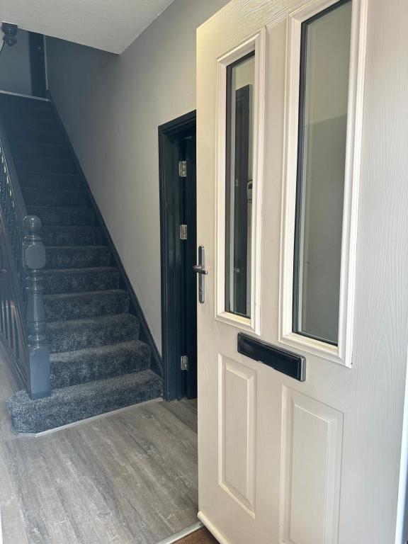 an open door with a staircase in a house at Castle Lodge in Nottingham