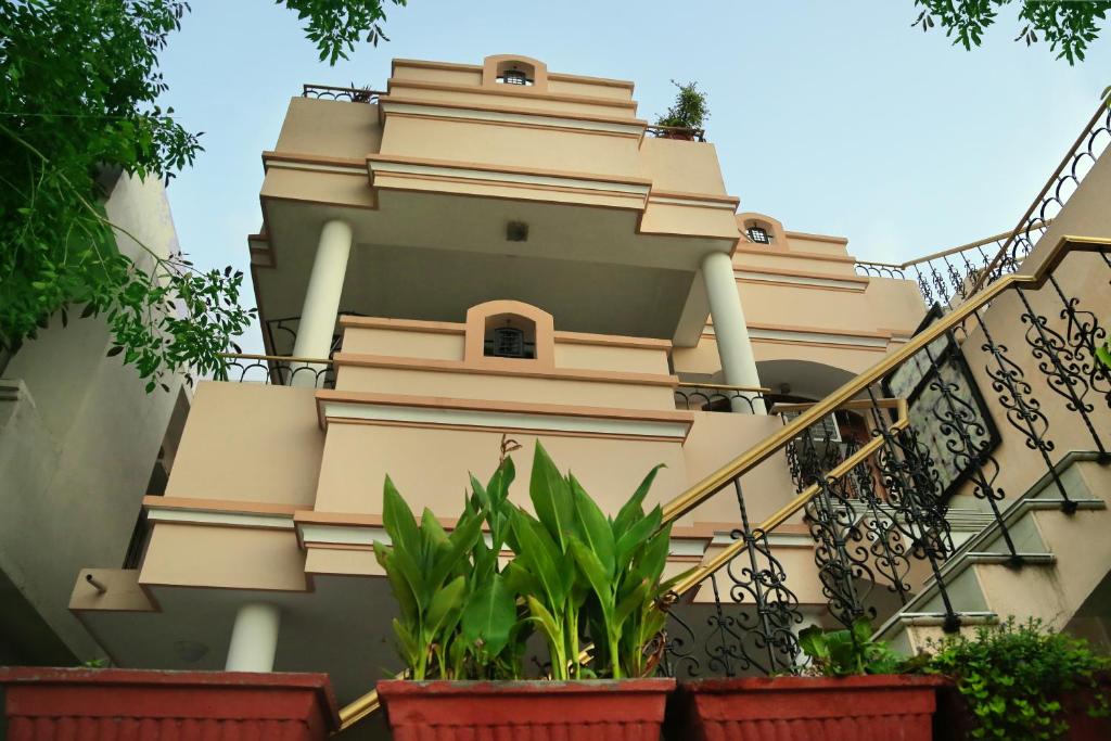 a building with stairs and plants at Raaga Home in Udaipur