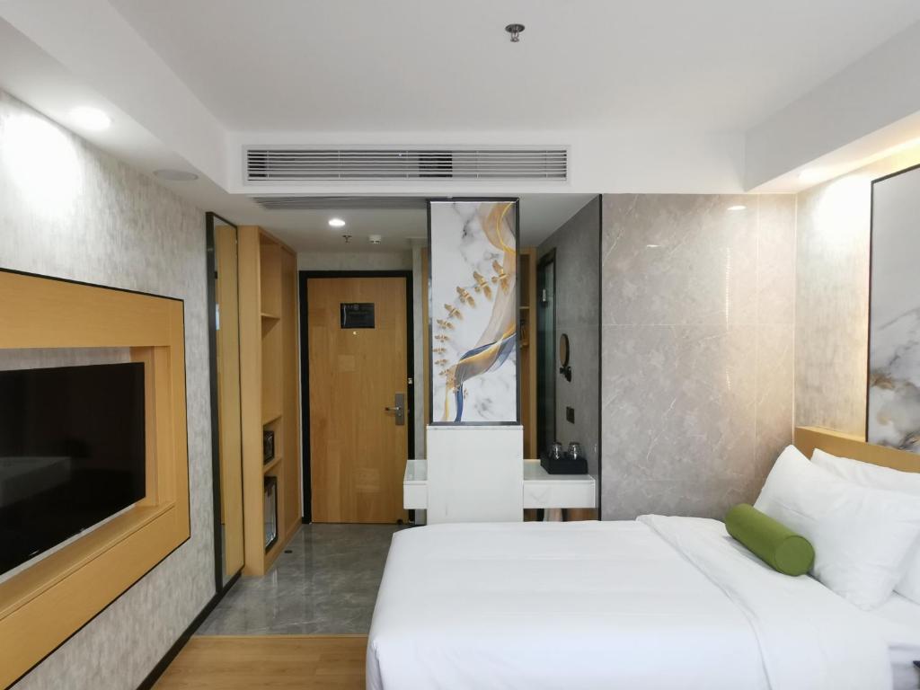 Postel nebo postele na pokoji v ubytování Connar Hotel - Shenzhen Futian