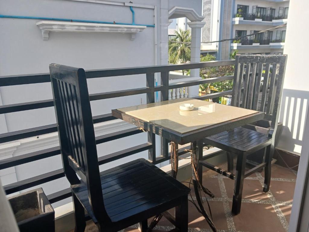 a table and two chairs on a balcony at Andy's Place in Siem Reap