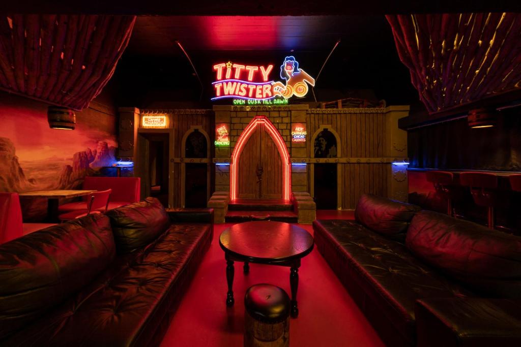 a bar with a couch and a sign that says tiny universe at FDTD Party & Sauna Lounge in Lahti