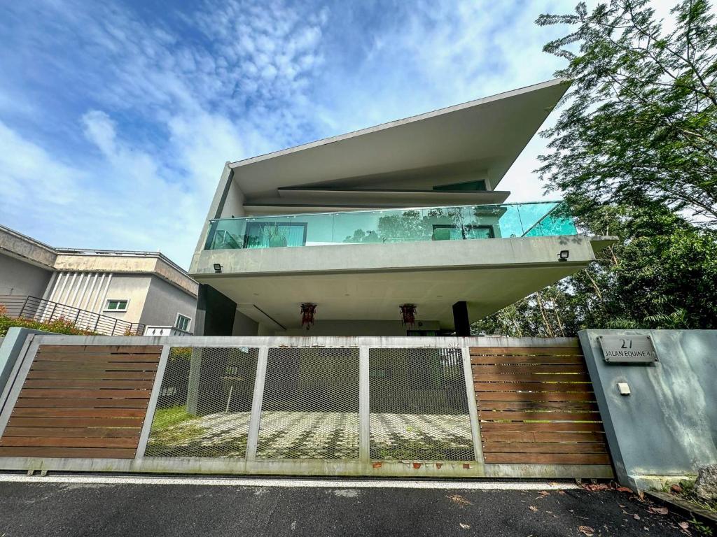 una casa con una valla delante de ella en Seri Kembangan Equine Villa with Pool by Iconique, en Seri Kembangan