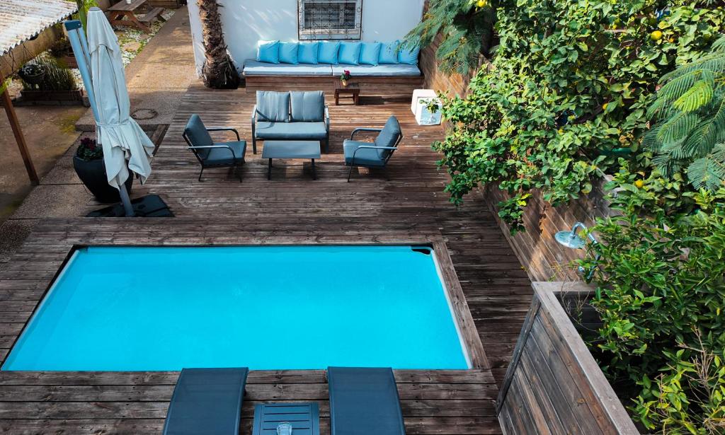 an overhead view of a swimming pool in a backyard at Villa Rosen at Ramat Hahayal TLV in Tel Aviv