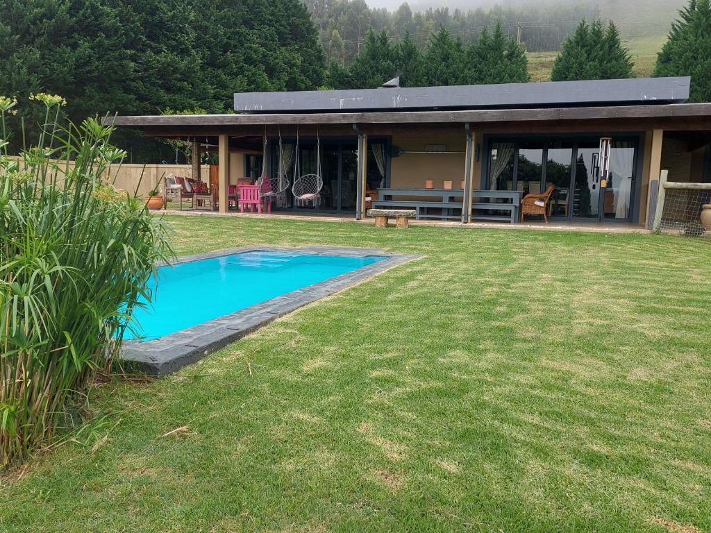 a house with a swimming pool in the yard at 9 Stoney Way House in Underberg