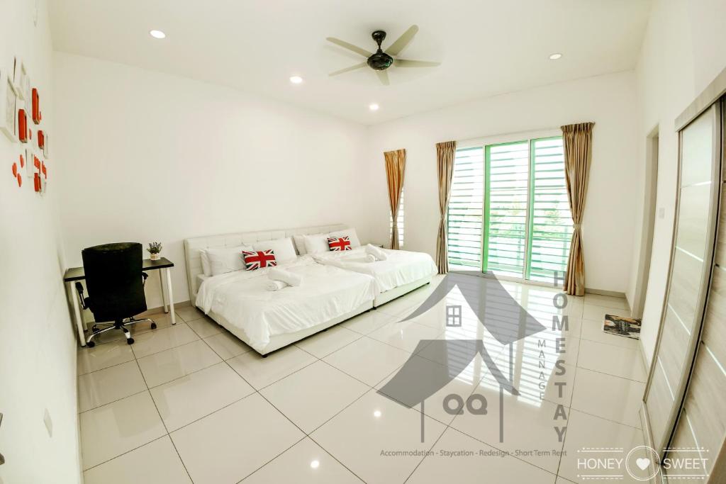 a white bedroom with a bed and a ceiling fan at Cosy Stay 99 Elvina Sendayan Dtempat舒适宁静之家 in Seremban