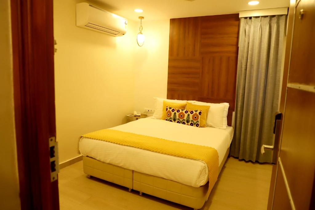 a hotel room with a bed in a room at Hotel Hinduja Empire in Surat