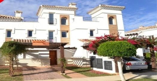 a white house with a car parked in front of it at Casa Bella Murcia in Roldán