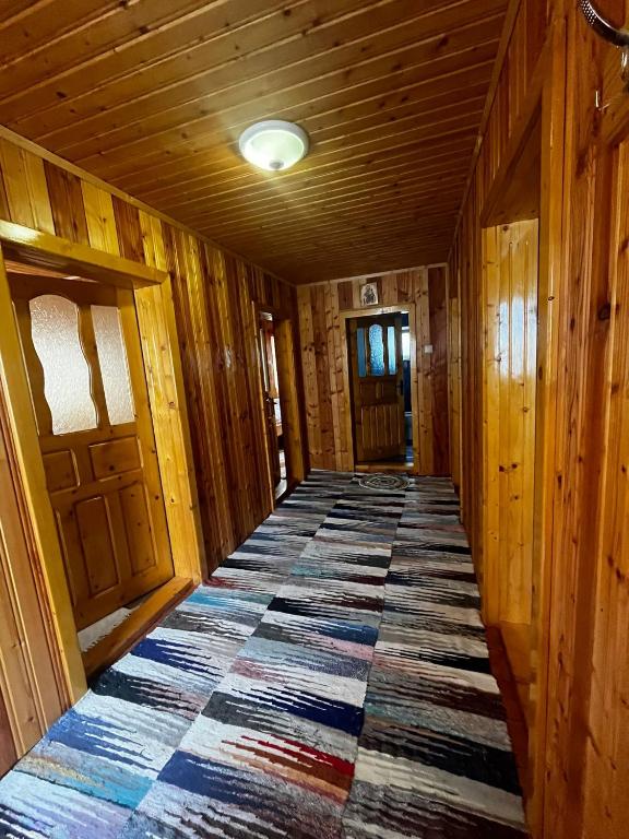 a hallway with a rug on the floor in a cabin at Cabana Alexe Mărișel in Mărişel
