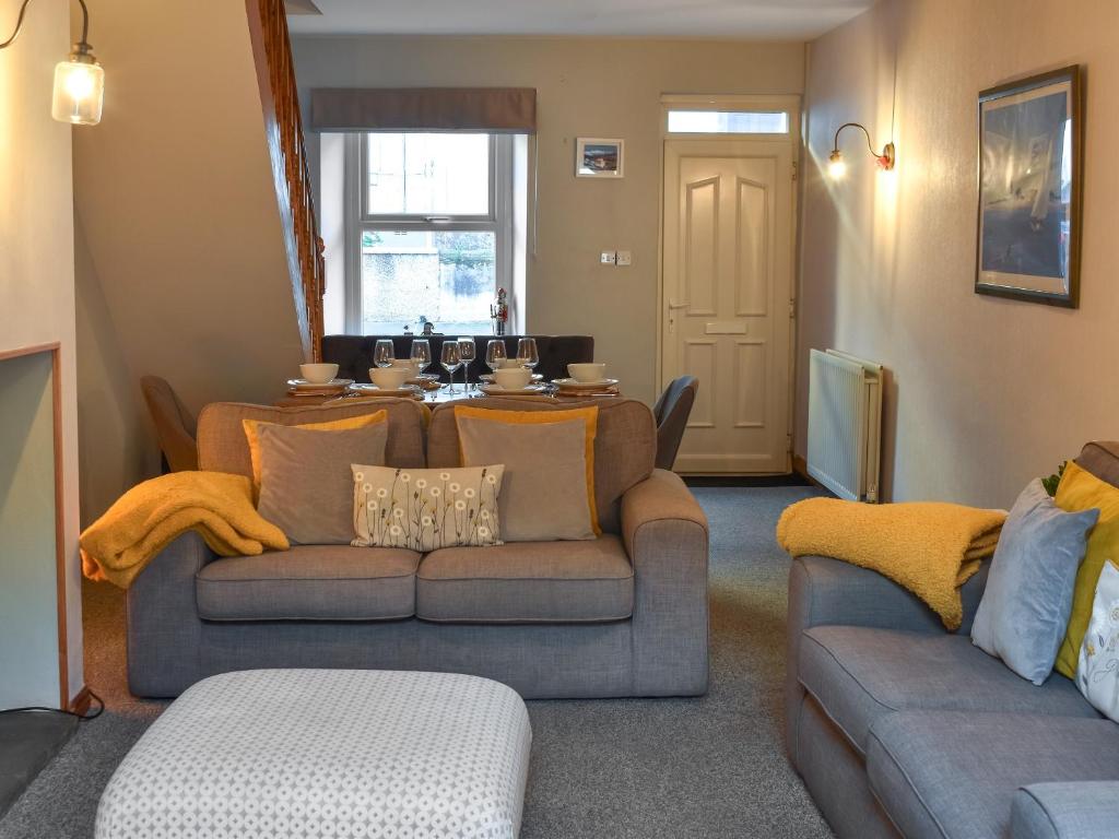 a living room with a couch and a table at Hugh Cottage in Whitehaven