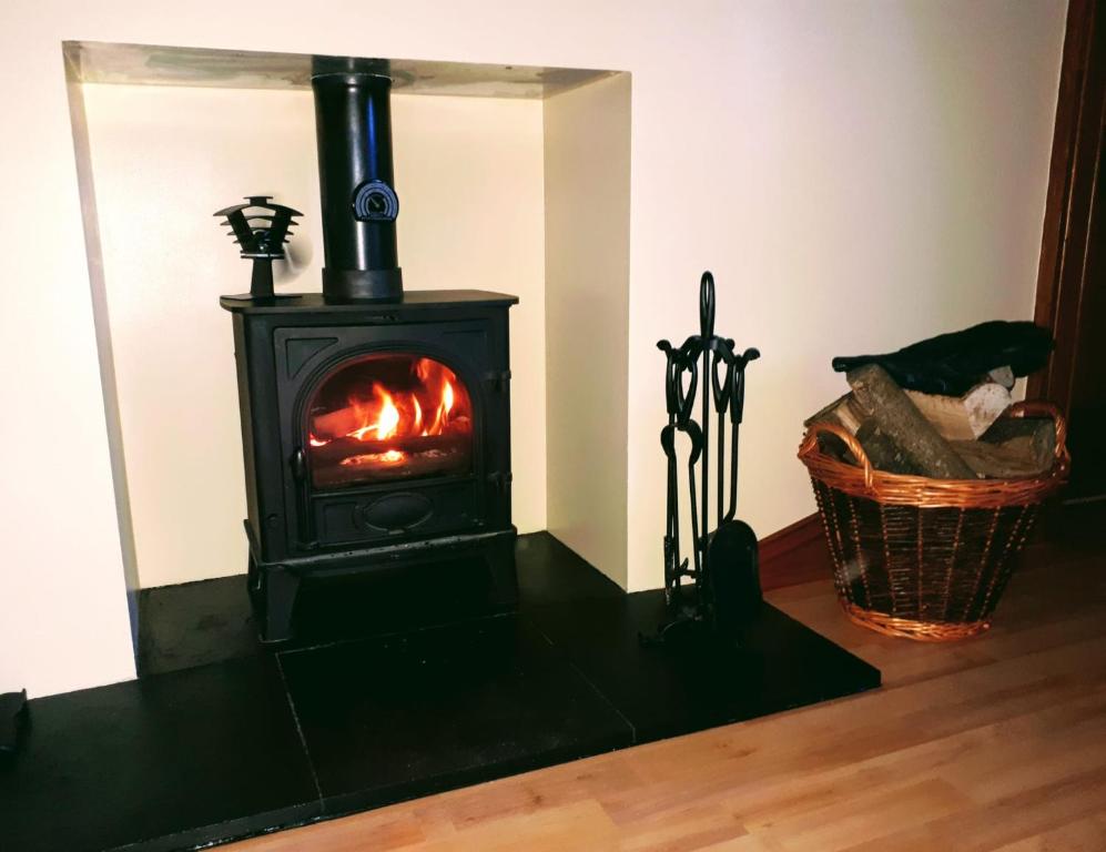 a stove in a room with a fire in it at Upper Deck in Eyemouth