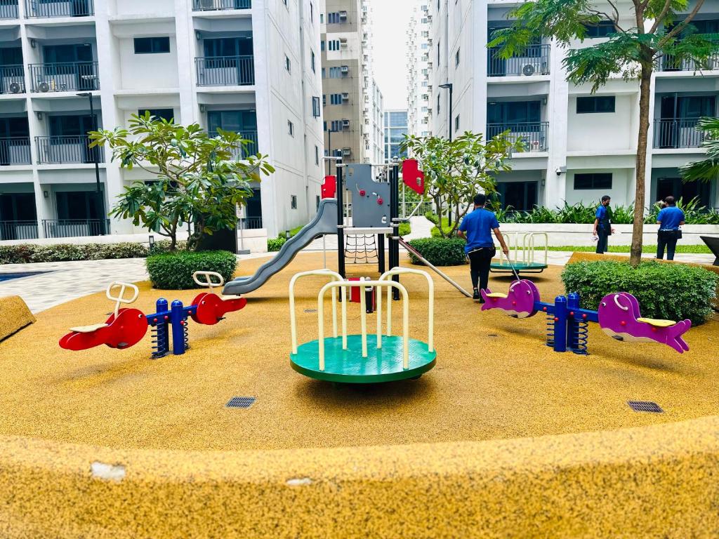 a playground in the middle of a city at Scandi-Style & Organic condo Shore 3 MOA in Manila