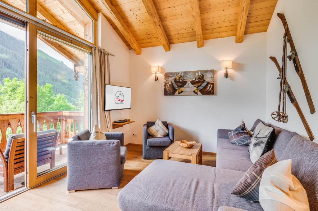 a living room with a couch and chairs at Chalet #16 am Sonnenhang in Neukirchen am Großvenediger