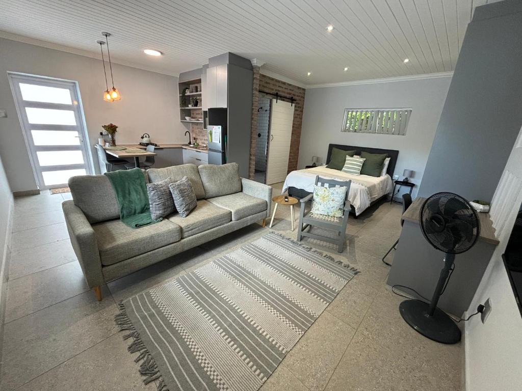 a living room with a couch and a bedroom at Prospect Road Cottage in Walmer