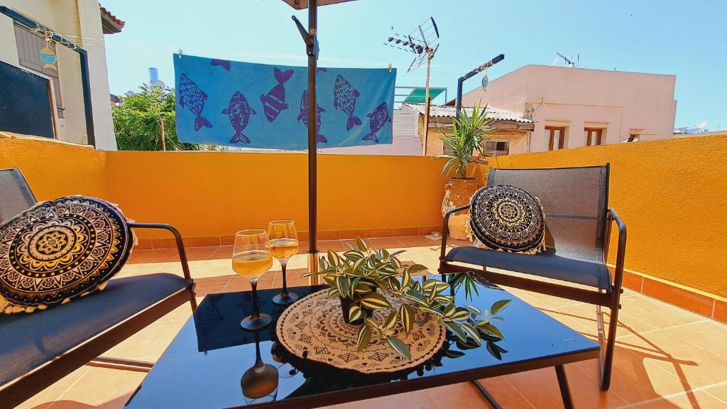 a patio with two chairs and a table with a plant at Beautiful house in the old town of Chania- 4 rooms in Chania Town