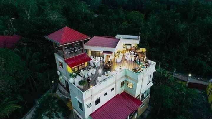 a building with a group of people on top of it at Café Darcey BnB in Tagbilaran City