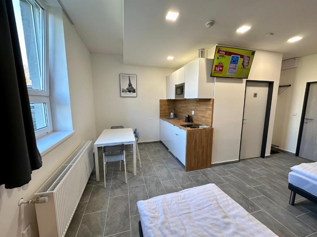 a small room with a kitchen and a table at Hotel Hangar in Mošnov
